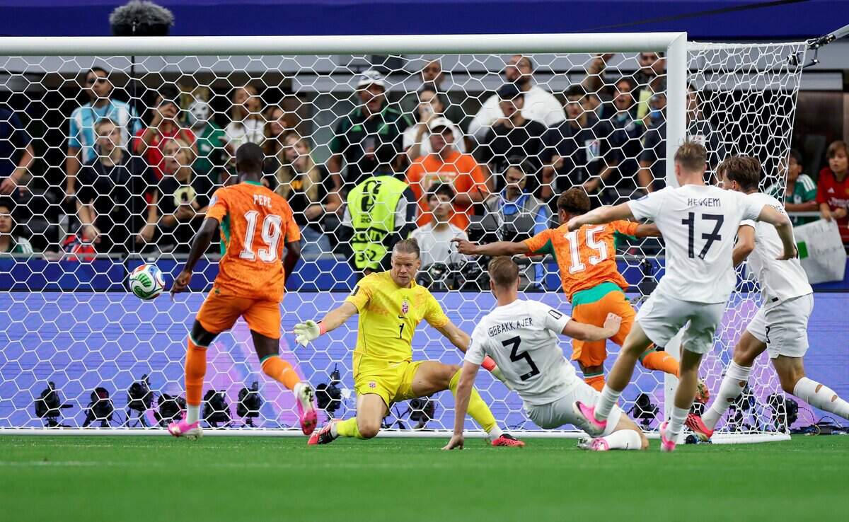 Ivory Coast forward Amad Diallo (15) kicks the ball past Norway goaltender Orjan Nyland during the 2026 FIFA World Cup knockout match on Tuesday, June 30, 2026, at Dallas Stadium in Arlington.